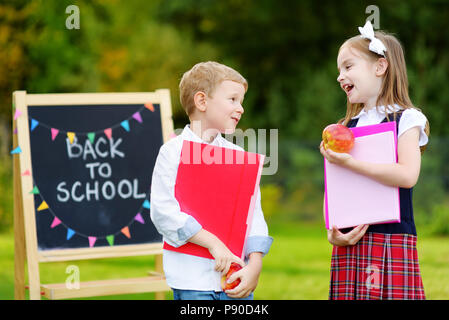 Zwei Entzückende kleine schoolkids Gefühl sehr aufgeregt über das Gehen wieder zur Schule Stockfoto