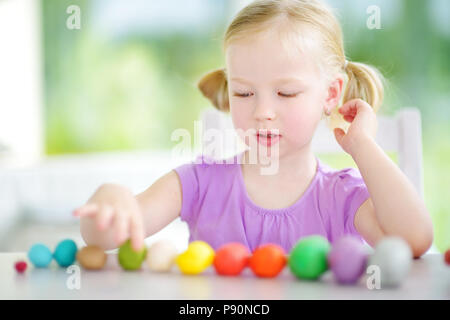 Süße kleine Mädchen Spaß mit bunten Modelliermasse an eine Kindertagesstätte. Kreative kid Spritzgießen zu Hause. Kind Spiel mit Plastilin oder Teig. Stockfoto