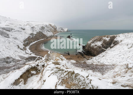 Mann-O Krieg Cove im Schnee an der Küste von Dorset. Stockfoto