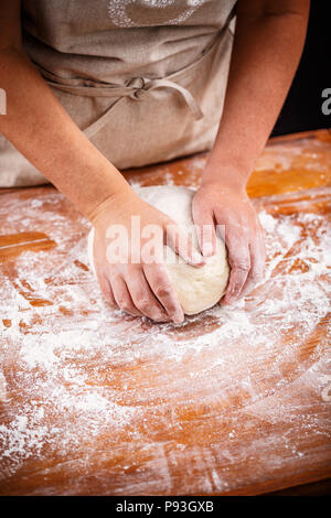 Weibliche Hände kneten und Brotteig Stockfoto