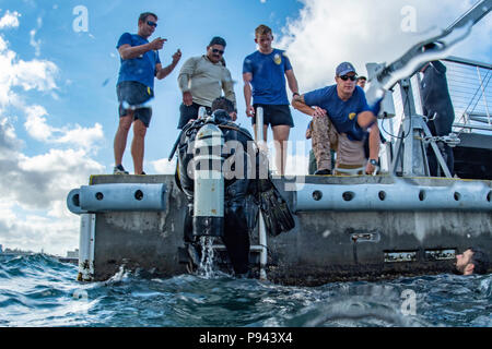 180706-N-CW 570-2305 JOINT BASE Pearl Harbor - HICKAM, Hawaii (6. Juli 2018) der US-Marine Taucher, auf Mobile Tauchen retten (MDSU) 1 und der Royal Australian Navy Taucher verlassen Sie das Wasser nach dem Tauchgang auf der USS Arizona Memorial Abschluss von Joint Base Pearl Harbor-Hickam während der Rand des Pazifik (Rimpac) Übung zugewiesen. 25 Nationen, 46 Schiffe, 5 U-Boote, über 200 Flugzeuge und 25.000 Angestellte beteiligen sich an Rimpac vom 27. Juni bis 2. August in und um die hawaiischen Inseln und Südkalifornien. Die weltweit größte internationale maritime Übung RIMPAC bietet eine un Stockfoto