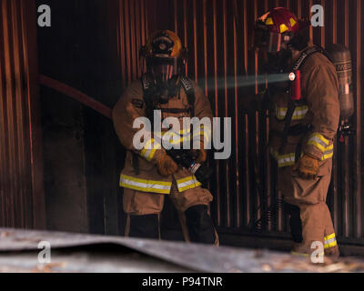 Feuerwehrmänner mit Die 144 Fighter Wing, Fresno, Kalifornien, einen simulierten Brand während der PATRIOT Norden Übung bei Volk Feld, Wis., Juli 14, 2018 löschen. PATRIOT ist ein jährlicher Inland Training durch die Nationalgarde gefördert, die auf die Erhöhung der Fähigkeit der lokalen, staatlichen und föderalen Organisationen zu koordinieren zusammen arbeiten als Reaktion auf Naturkatastrophen oder von Menschen verursachten Not- und konzentriert. (U.S. Air National Guard Foto: Staff Sgt. Wendy Kuhn) Stockfoto