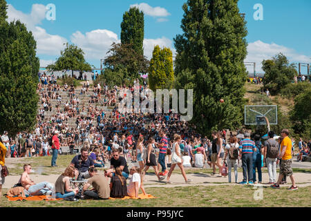 Berlin, Deutschland - Juli 2018: Personen, die sonnigen Sommertag auf der Wiese in belebten Park (Mauerpark) in Berlin City Stockfoto