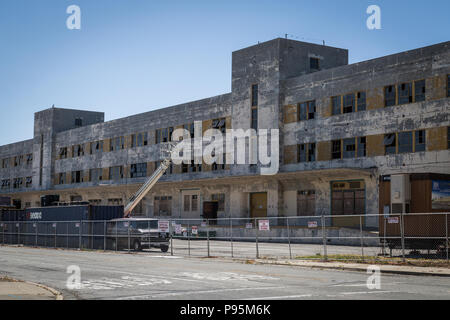 Ein verlassenes Gebäude aus Beton, der Teil der alten Naval Air Station in Alameda, mit kaputten Fenstern. Stockfoto