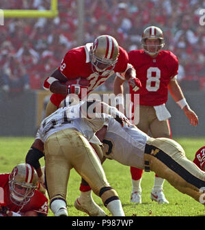 San Francisco, Kalifornien, USA. 15 Nov, 1992. San Francisco 49ers gegen New Orleans Saints im Candlestick Park Sonntag, 15. November 1992. 49ers Schlagen Heiligen 21-20. San Francisco 49ers zurück läuft Ricky Watters (32) springt über Verteidiger. Credit: Al Golub/ZUMA Draht/Alamy leben Nachrichten Stockfoto