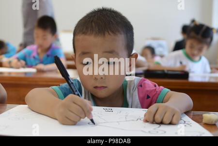 Linxia, Gansu Provinz Chinas. 16. Juli 2018. Kinder lernen Malen an einer Jugend activity center in Linxia, im Nordwesten der chinesischen Provinz Gansu, 16. Juli 2018. Die Teilnehmer lernen verschiedene Fähigkeiten während der Sommerferien. Credit: Shi Youdong/Xinhua/Alamy leben Nachrichten Stockfoto