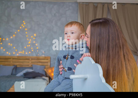 Portrait von kleinen Jungen auf hölzernen Schaukelpferd Stockfoto