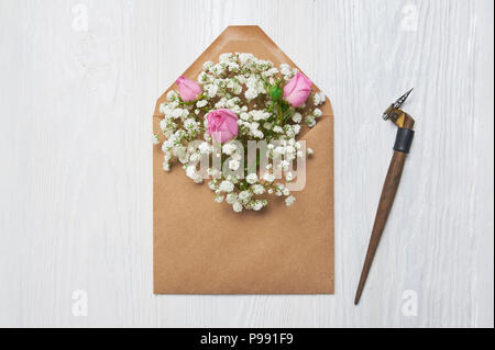 Kalligrafische Feder einen Umschlag mit Blumen und einem Brief, Grußkarte für Valentines Tag mit Platz für Ihren Text. Flach, Ansicht von oben Foto Mock up Stockfoto