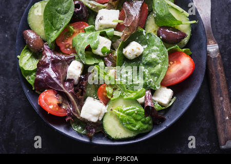 Griechische Feta und Oliven Salat mit Tomaten, Gurken und vinaigrette Dressing Stockfoto