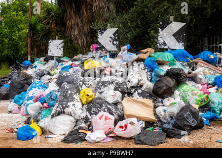 Gestapelte Mülltüten auf einer Straße auf der griechischen Insel Korfu Stockfoto