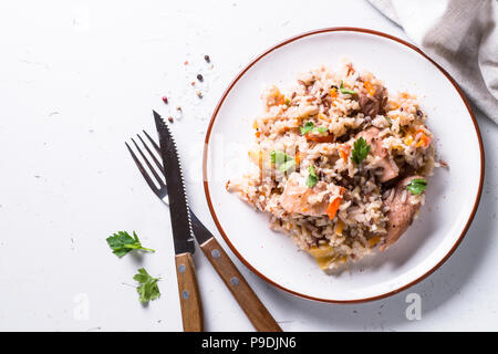 Pilav mit Putenfleisch und brauner Reis auf weißer Tisch. Ansicht von oben. Stockfoto