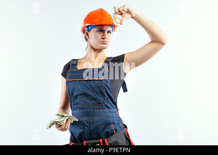 Junge Frau mit in einer Hand Banknoten in eine andere Münze Bitcoin. Stockfoto