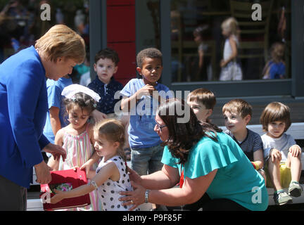 Deutschland, Köln. 18 Juli, 2018. Die deutsche Bundeskanzlerin Angela Merkel (CDU) besucht die Caritas Zentrum Kalk und erhält ein Self-made Buch aus zahlreichen Kinder. Credit: Oliver Berg/dpa/Alamy leben Nachrichten Stockfoto