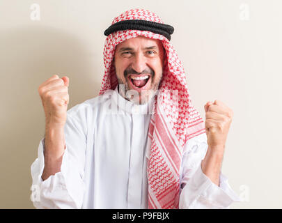 Senior arabische Menschen schreien stolz und feiern Sieg und Erfolg sehr aufgeregt, jubelnde Emotion Stockfoto