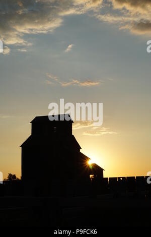 Prairie Dawn mit Silhouette von getreidesilo, Saskatchewan, Kanada Stockfoto