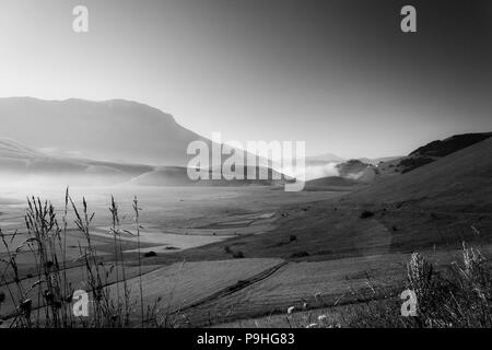 Anzeigen von Castelluccio Di Norcia (Umbrien) in der Dämmerung, bei Nebel, große Wiesen und völlig leeren Himmel Stockfoto