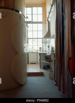 Blick vom Saal mit gebogenen Wand auf moderne Küche im Dachgeschossausbau Stockfoto