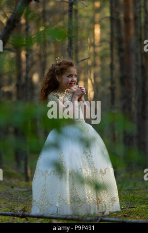 Kleine Prinzessin wallks in ein Abendkleid in einem Sommer Wald, Tageslicht Stockfoto