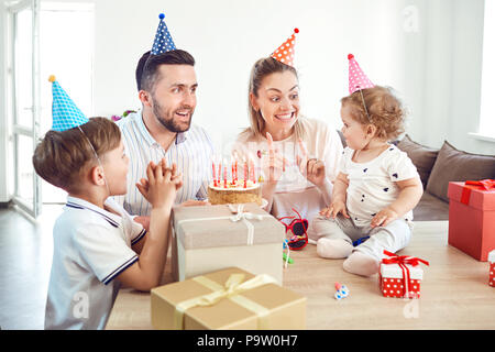 Eine glückliche Familie mit Kuchen feiert Geburtstag. Stockfoto