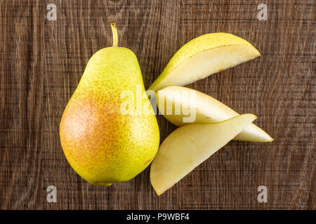 Gruppe von einem ganzen drei Scheiben frische rote Birne forelle Vielfalt flatlay auf braunem Holz Stockfoto