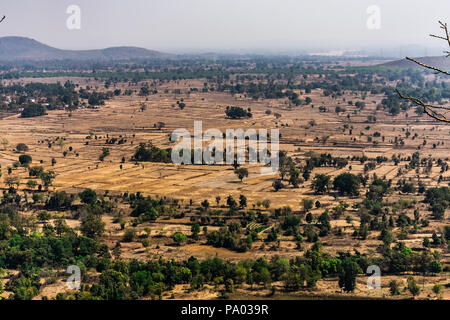 Top View oder Luftaufnahme von der Spitze eines Rocky Mountain von frischem Grün und Gelb Reisfelder an einem sonnigen Tag im Sommer in einem ländlichen Dorf in Indien. Stockfoto