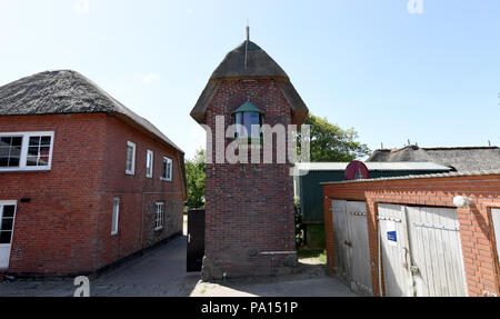 Oland, Deutschland. 05 Juni, 2018. Den Leuchtturm von der Hallig Oland. Es ist ziemlich Unremarkably an der nordwestlichen Seite der nur Wohnung Damm der Hallig entfernt. Rote Ziegelsteine, strohgedeckten Dach mit Schilf und mit einer Firsthöhe von nur 7, 45 Meter ist es kaum von anderen Gebäuden an der Wohnung Damm unterscheidet. Credit: Carsten Rehder/dpa/Alamy leben Nachrichten Stockfoto