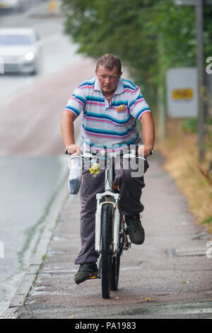 Ashford, Kent, Großbritannien. 20 Jul, 2018. UK Wetter: ein Mann mit dem Fahrrad in T-Shirt in den strömenden Regen durchnässt. © Paul Lawrenson 2018, Foto: Paul Lawrenson/Alamy leben Nachrichten Stockfoto