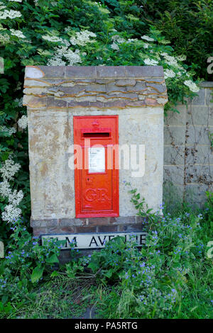 Mauereinputz Letter Box von blühenden Pflanzen umgeben Stockfoto