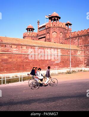 Blick auf das Rote Fort mit der lokalen Bevölkerung auf einem Dreirad im Vordergrund, Delhi, Delhi Union, Indien. Stockfoto