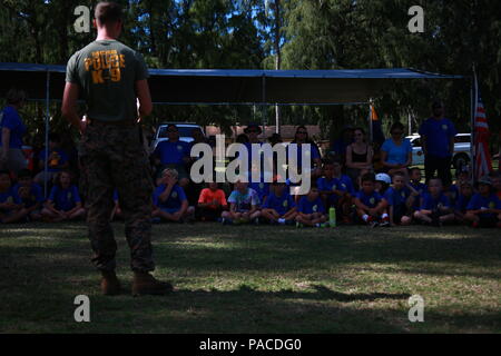CPL Michael Foster, eine militärische Working Dog Handler und stellvertretender Chef Trainer für die Provost Marshal militärische Arbeitshunde Büroeinheit mit Hauptsitz Bataillon vom Marine Corps Base Hawaii, verleiht eine Schutzklasse über Militärhunde Cub Scout Truppe 311 an Bord Marine Corps Training Bereich Balg, 5. März 2016. Die Wölflinge erhielten eine militärische Hund Demonstration präsentiert die Hunde-Funktionen. Marines und zivilen Beamten verschiedene Befehle gegeben ihre Hunde, ihre Intelligenz und ihren Gehorsam zu zeigen. Die Hundeführer zermürbte auch eine Biss-Jacke für ein mock nehmen die Hunde Stockfoto