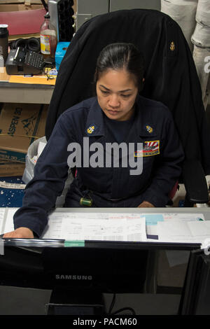 Philippinischen MEER (21. März 2017) Chief Logistikspezialisten Sheryl Gutierrez, führenden Chief Petty Officer der Lagerverwaltung, von Batangas City Philippinen, Prozesse eine hohe Priorität Bestellanforderung in der Lagerverwaltung Büro an Bord amphibisches Schiff USS BONHOMME RICHARD (LHD6). Bonhomme Richard, dem Flaggschiff der Bonhomme Richard Expeditionary Strike Group, mit Eingeschifft 31 Marine Expeditionary Unit (MEU) ist auf einer Routinepatrouille in der Indo-Asia - Pazifik Region warfighting Bereitschaft und Haltung als ready-Response Force für jede Art der Kontingenz zu verbessern. Stockfoto