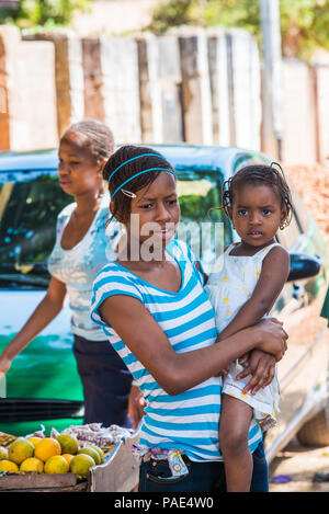 BANJUL, Gambia - Mar 14, 2013: Unbekannter gambischen Frau und ihr kleines Baby auf dem Markt in Gambia, Mar 14, 2013. Menschen in Gambia Leiden von povert Stockfoto