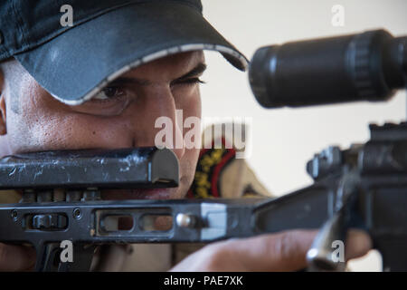 Ein irakischer Soldat eingeschrieben in das irakische Sniper School verbirgt sich in einem Gebäude während der Tarnung Training im Camp Taji, Irak, 6. März 2016. Der Soldat nahm an Sniper camouflage Schulung seiner grundlegenden Infanterie Fähigkeiten zu verbessern. Die Schulung ist Teil des gesamten Combined Joint Task Force - inhärenten Building Partner Kapazität mission Lösen, die militärische Fähigkeit der irakischen Sicherheitskräfte im Kampf gegen die Islamischen Staat im Irak und der Levante zu erhöhen. (U.S. Armee Foto von SPC. William Lockwood/Freigegeben) Stockfoto