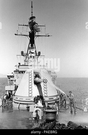 Besatzungsmitglieder geben USS Rumpf (DD-945) einen Süßwasser-Abwaschbares, während Operationen vor der südlichen Küste von Kalifornien, 16. September 1975. Von Hull experimentelle 8/55 Mark 71 große Kaliber leichte Waffe ist, die Aufmerksamkeit der Schlauch Mann in dieser Ansicht. Stockfoto