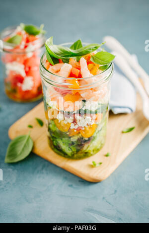 Lecker Salat mit Garnelen serviert im Glas auf dem Tisch. Bereit zu essen. Detox sauber Essen Konzept Stockfoto