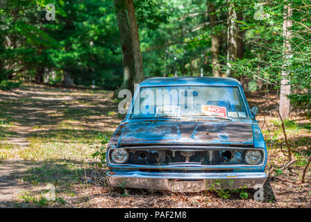 Eine alte Dodge sitzt an der Spitze einer Schmutz Auffahrt mit Warnzeichen in der Windschutzscheibe Stockfoto