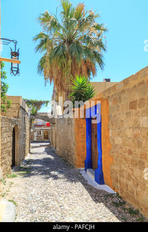 Blick auf die Straße in der Altstadt von Rhodos, Dodekanes, Griechenland mit gelben und blauen Eingang Stockfoto
