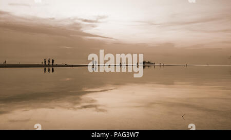Wunderschöne natürliche Landschaft silhouette Touristen Reflexion über den Strand in der Nähe von Nathon Pier und Sky bei einem Sonnenuntergang über dem Meer bei Ko Samui Island, Sure Stockfoto