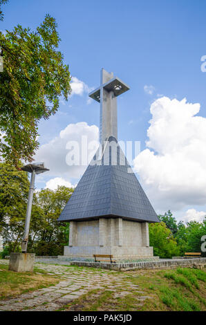 CLUJ-NAPOCA, Rumänien - 18. AUGUST 2015: Kreuz auf dem cetatuia Hügel über Cluj Napoca Stadt gebaut, Transylvania Region Rumäniens an einem bewölkten Himmel wi Stockfoto