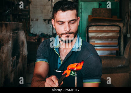 Einem jungen Glasbläser bläst ein Glas Schwan in einem Workshop in Hebron, Palästina Stockfoto