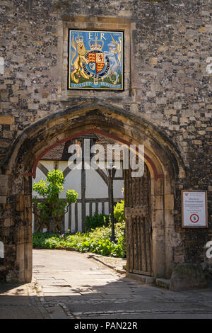 Priory Gate und Teil der Cheyney Gericht durch die Kathedrale von Winchester, Hampshire, England. Wappen für Königin Elizabeth II. Stockfoto