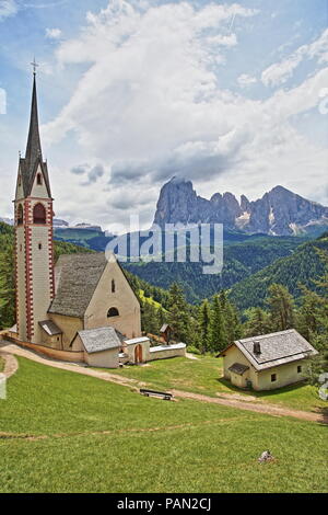 St. Jakob Kirche in der Nähe von Santa Cristina und St. Ulrich mit Langkofel und Plattkofel Bergen im Hintergrund, Gröden, Dolomiten, Italien Stockfoto