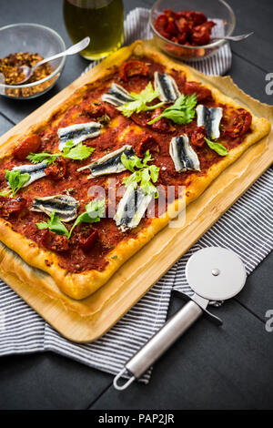 Pizza Marinara garniert mit Sardellen und Petersilie Stockfoto