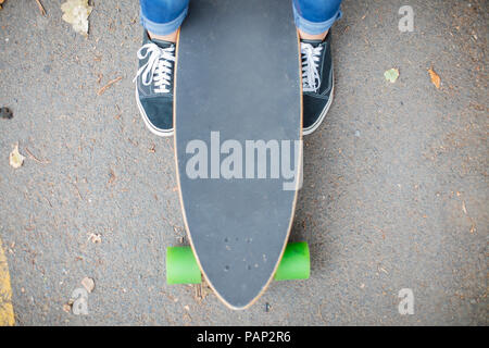 In der Nähe der Füße neben Skateboard Stockfoto