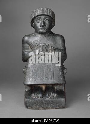 Statue von gudea. Kultur: Neo-Sumerian. Abmessungen: 17 3/8 x 8 1/2 x 11 5/8 in. (44 x 21,5 x 29,5 cm). Datum: Ca. 2090 v. Chr.. Das AKKADISCHE Reich brach nach zwei Jahrhunderten der Herrschaft, und in den darauf folgenden 50 Jahren, lokalen Königen regiert unabhängige Stadtstaaten im südlichen Mesopotamien. Die Stadt - Zustand von Lagash produziert eine bemerkenswerte Anzahl von Statuen der Könige sowie die sumerischen literarischen Hymnen und Gebete unter der Herrschaft von Gudea (Ca. 2150-2125 v. Chr.) und seinem Sohn Ur-Ningirsu (Ca. 2125-2100 v. Chr.). Im Gegensatz zu der Kunst des Akkadischen Zeit, die durch dynamische Naturalismus geprägt war, hat sich die Arbeit Stockfoto