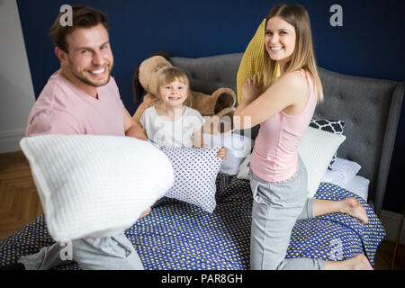 Glückliche Familie Spaß im Schlafzimmer, mit einer Kissenschlacht Stockfoto