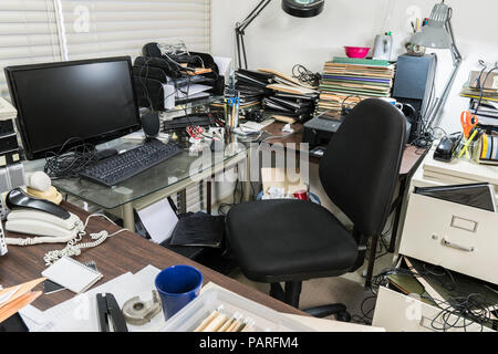 Unordentliches Büro Schreibtisch mit Stapeln von Dateien und ungeordnet durcheinander. Stockfoto
