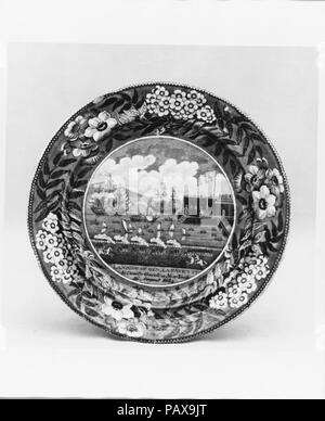 Platte. Kultur: Britische (US-Markt). Abmessungen: Durchm. 10 in. (25,4 cm). Schöpfer: James und Ralph Clews (Briten, Cobridge, Stoke-on-Trent, aktive Ca. 1818-36). Datum: Ca. 1824-34. Diese blauen und weißen Transfer - gedruckt Steingut Teller gemacht durch die Staffordshire Firma James & Ralph Clews mit Blick auf den Siegeszug der Landung von General Lafayette (1757-1834) in den Hafen von New York am 16. August 1824, wo er von der amerikanischen Marine Schiff" Bundeskanzler Livingston' traf und zum Schloss Garten begleitet für eine sehr große Feier von Tausenden von patriotischen Gratulanten. Museum: Metropolitan Museum von Ar Stockfoto