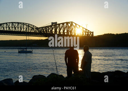 Leute Angeln vom Parc de la Marina de La Chaudière, St-Romuald, Quebec, mit dem St Lawrence Rier in Pont du Quebec hinter Stockfoto