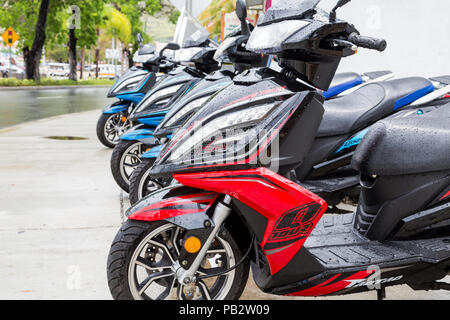 Eine Reihe von bunten Mopeds nach einem Regen in St. Thomas Stockfoto